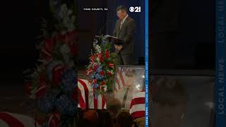 Family friend Mark Bentzel speaks on behalf of Cody Becker's family at funeral for slain officers