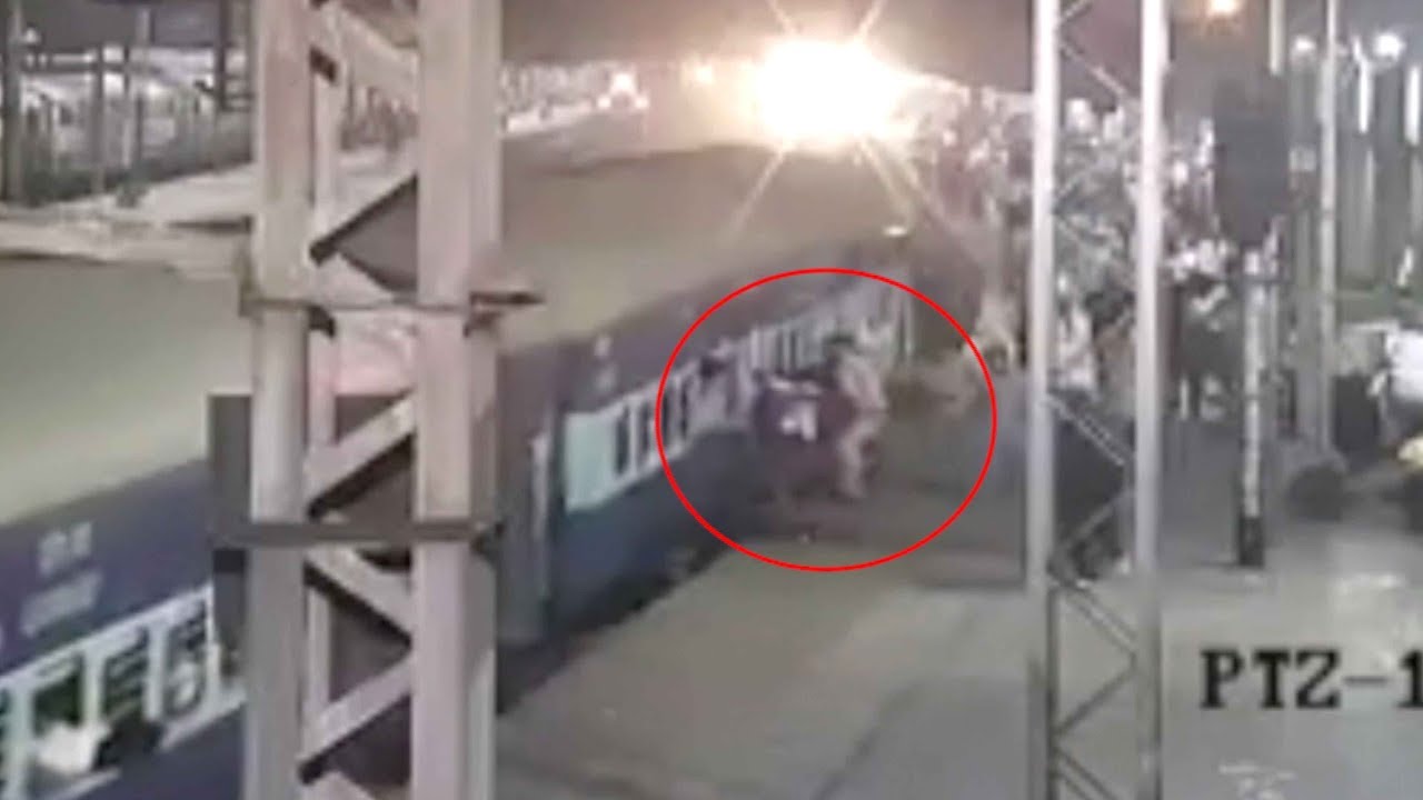 Man hanging from moving train saved by police officer in India - YouTube