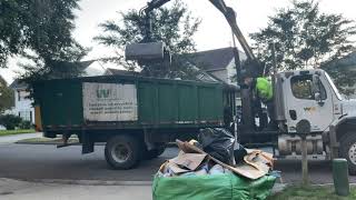 Waste Management Claw Truck Picking Up Huge Bag Full Of Trash
