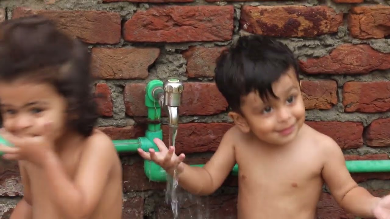 kids fun while talking bath in very hot summer in pakistan