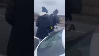 Украинские полицейские отгоняют простых смертных от иномарок элиты, покидающей страну.