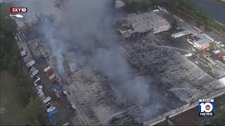 Massive warehouse fire continues burning in northwest Miami-Dade