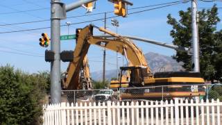 CAT 345B Excavator moving a trench wall into place