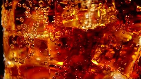 Pouring Cola Over Ice Stock Video