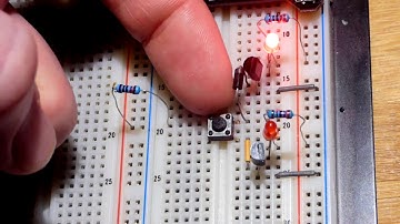 How to wire a pushbutton switch and 2 2N2222 NPN BJT controlled alternating flashing LEDs circuit
