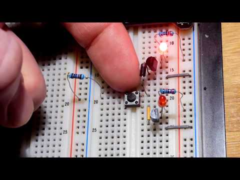 How to wire a pushbutton switch and 2 2N2222 NPN BJT controlled alternating flashing LEDs circuit