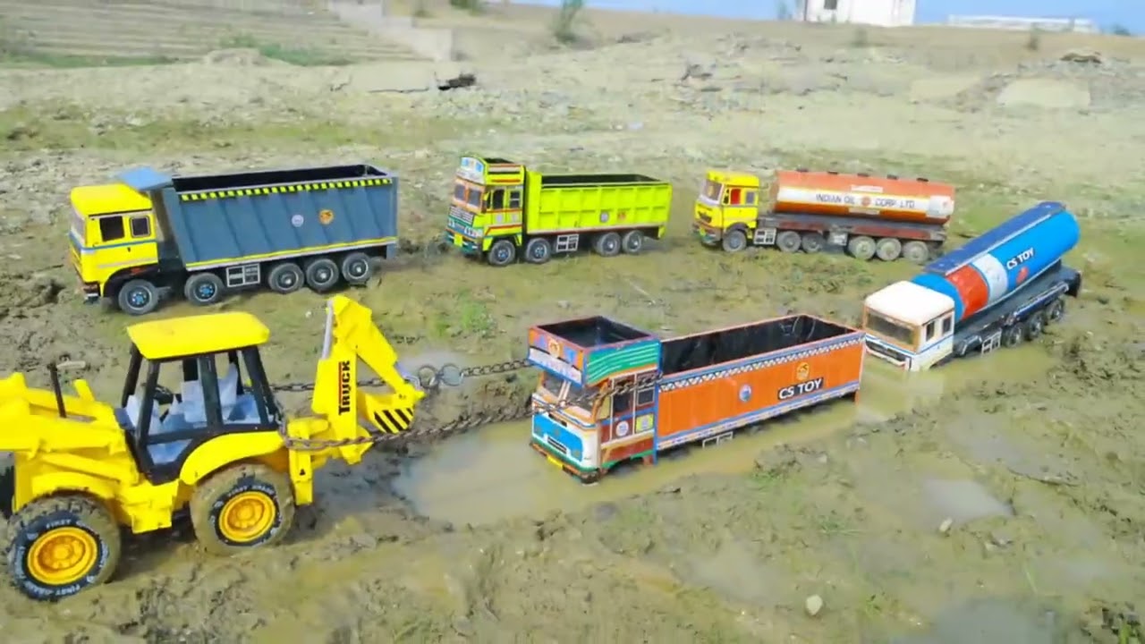 A little boy's favorite toy oil tanker and excavator are used in a lakeside rescue game. 