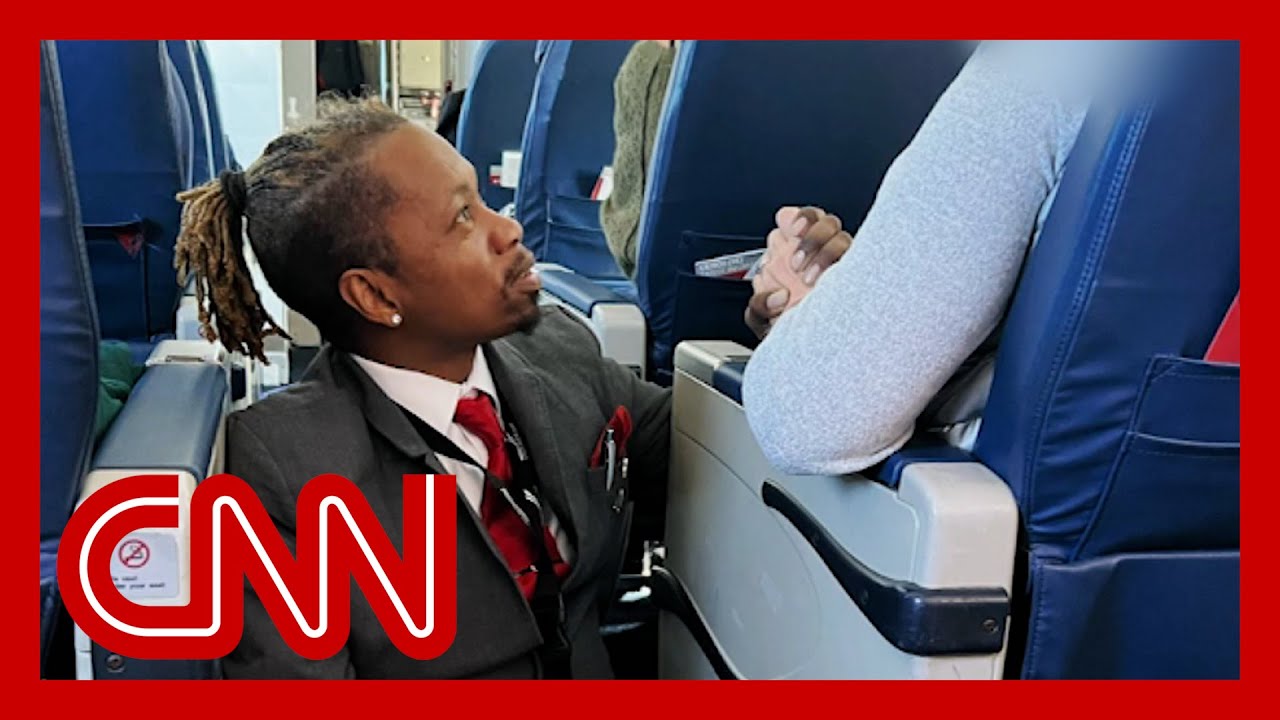 Photo of flight attendant goes viral.  Hear what he said to the passenger