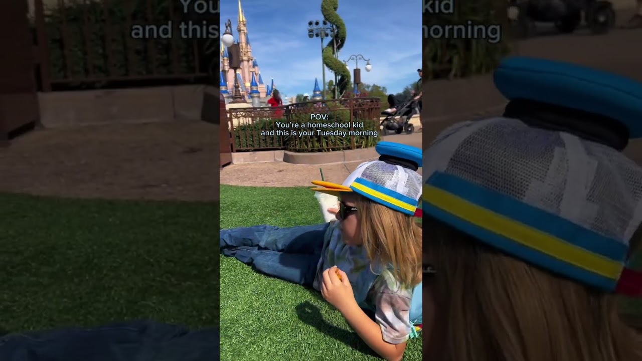 Sometimes homeschool is sitting on the hub grass enjoying Starbucks at Magic Kingdom