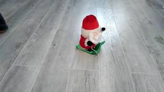 Санта едущий на санях и поющий песню (игрушка)