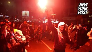 Anti-Israel protesters carry flares to march on NYPD HQ after over 150 arrested at NYU