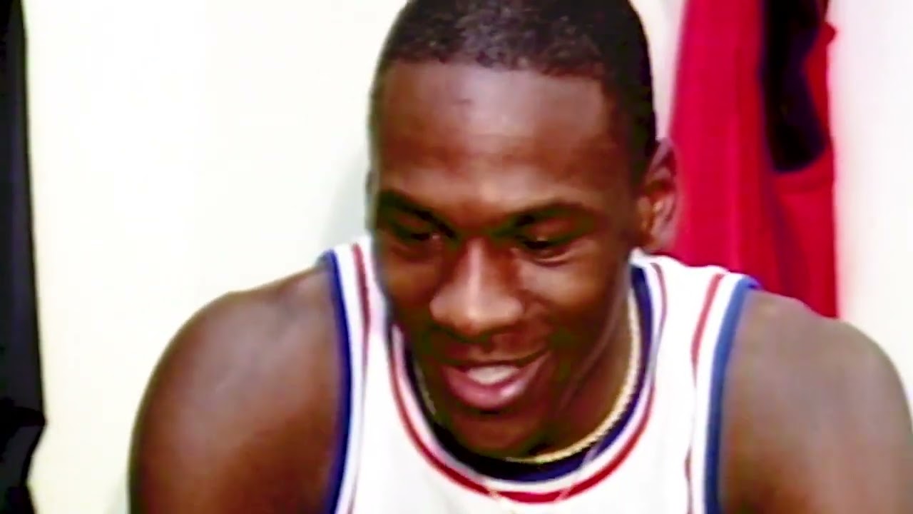 Michael Jordan tying up sneakers at first All-Star Game in 1985