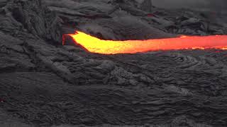 Up Close Footage of Lava Flowing Down Smoothly Like Water as Camera Zooms In