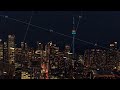 Unique aerial perspective of Toronto skyline at night with CN Tower illuminating metropolis