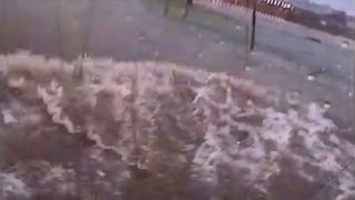 See in car as it's swept away in flood