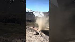 Scenic Moment as a Dust Devil Passes a Mountain