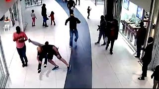 Cell phone thief in mall gets hard tackled.