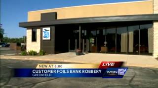 A bank customer interrupted a robbery at a Greenfield bank on Saturday."