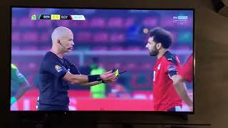 The referee offers his whistle and cards to Mo Salah after...
