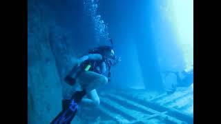 Female Scuba Diver Explores Sunken Wreck