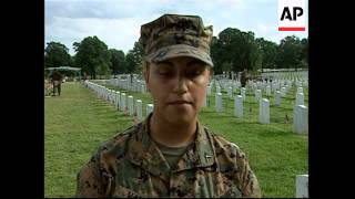 Servicemen put US flags on graves at Arlington