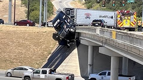 18-wheeler hangs off bridge