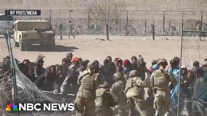 Migrants Seen Tearing Down Barrier At Border