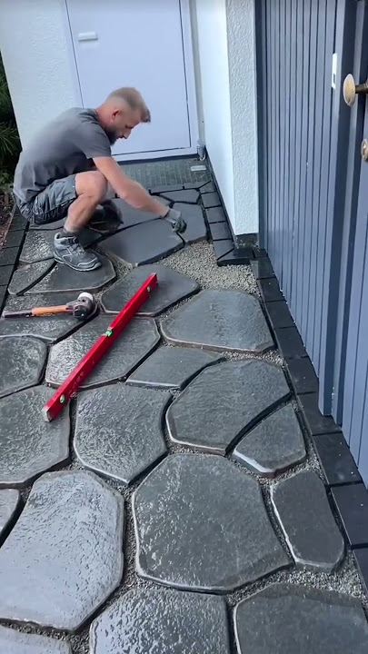 This man shows how to install paving stones in the yard of a house #pavingstone #construction