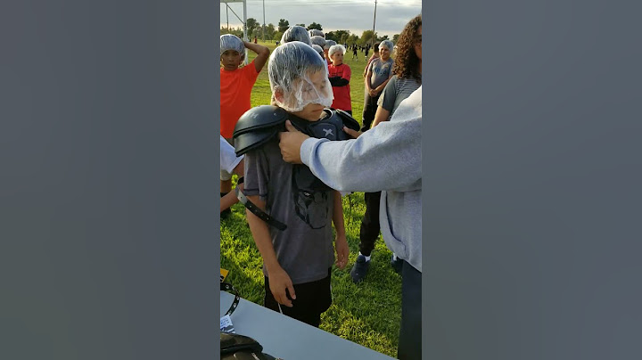 Trying on the football shoulder pads