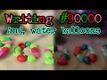 Writing #90000 - POPPING a tribe of WATER BALLOONS shaped like '90000'
