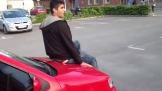 Idiot guy sits on a VW polo.