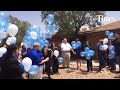 Community members and staff from the Child Crisis Center of El Paso release balloons in honor of vic
