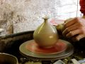 Throwing a clay pottery table salt pot on the wheel