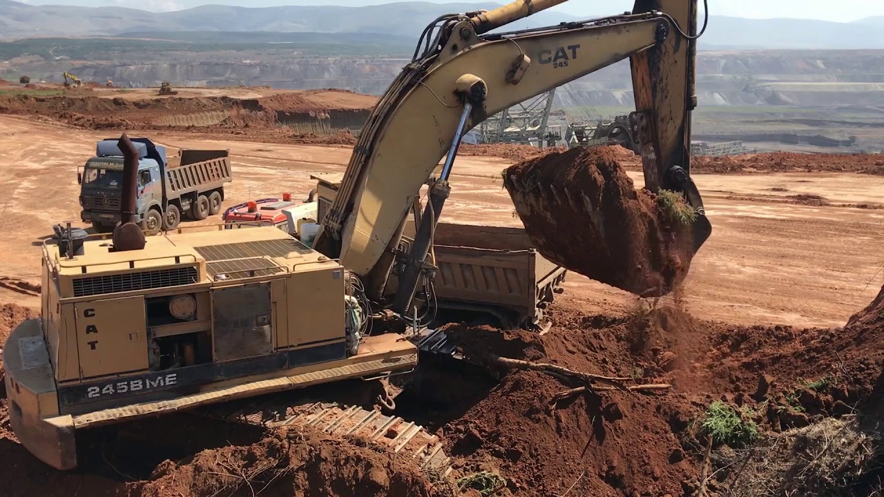 Caterpillar 245B Excavator Loading Trucks