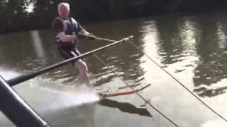 Barefoot waterski by stepping off slalom ski-- instruction