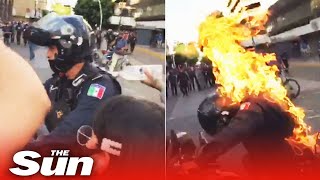 Cop is set on fire during anti-police protests in Mexico sparked by builder ‘beaten to death’