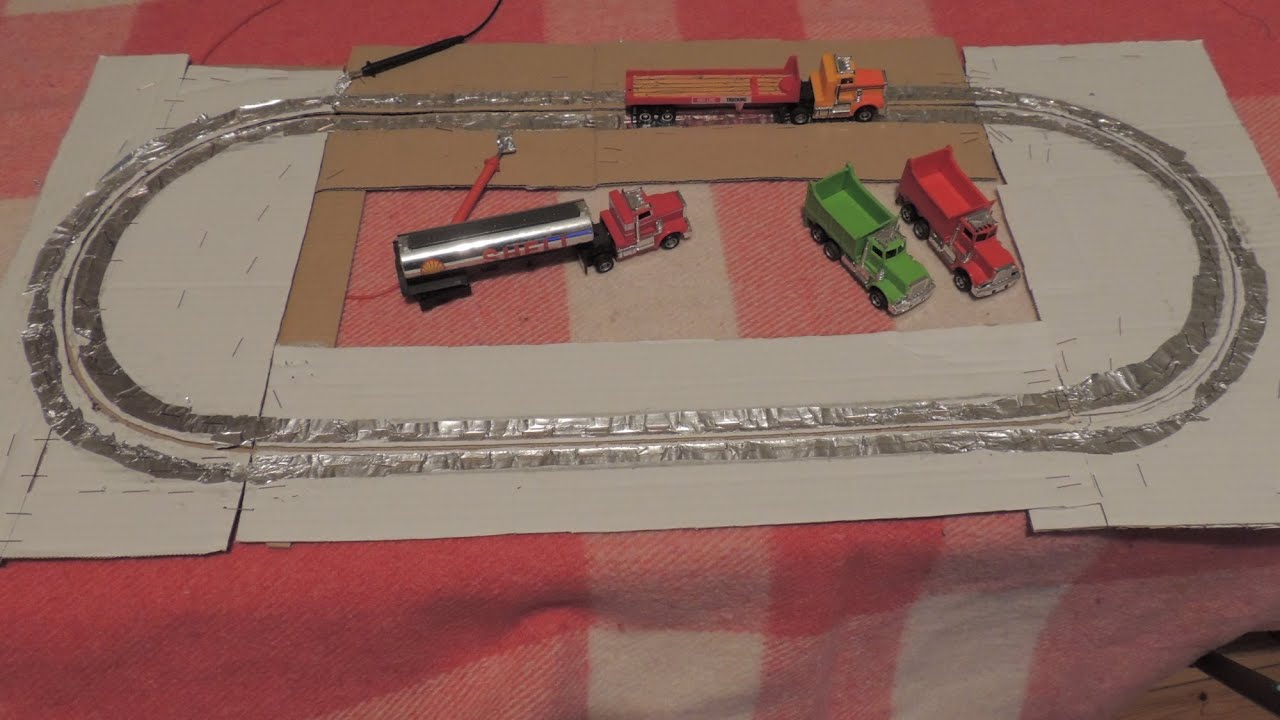 Tyco slot cars trucks & lorries on homemade track of cardboard