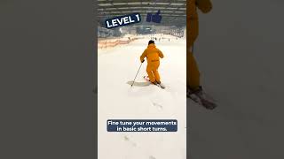 3 levels of short turns on a green slope (skiing)