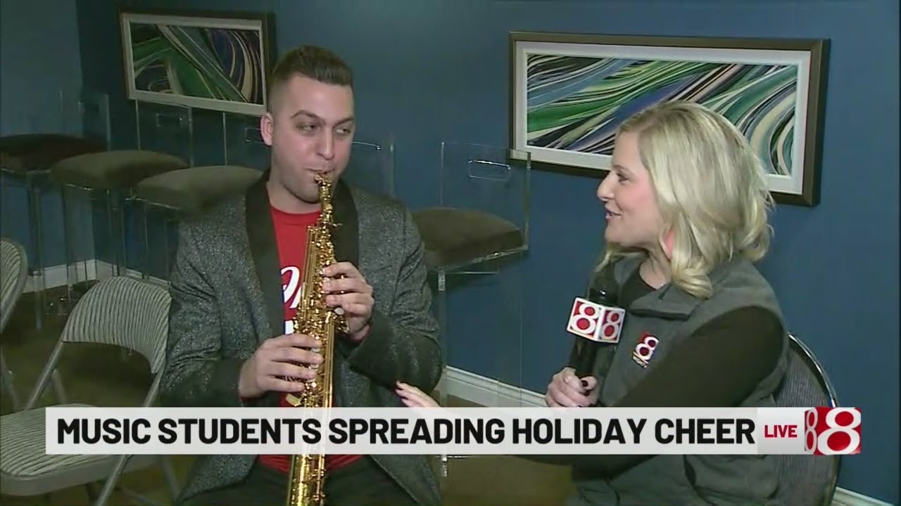 Group of musicians singing, spreading Christmas cheer .