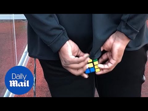 Calvin Anderson completes Rubik's Cube behind his back