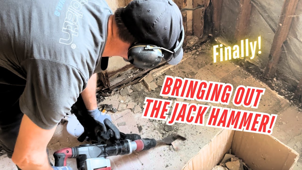 Bringing out the jack hammer! First layer of the bathroom floor tiles are finally removed!