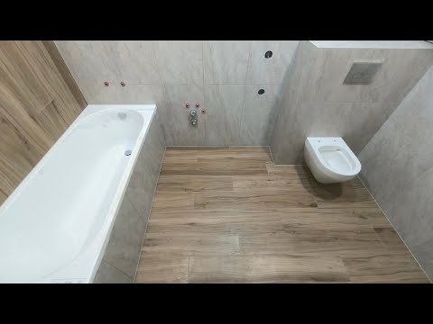 Laying tiles in the bathroom.