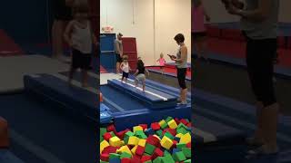 Boy pushes girl into foam pit