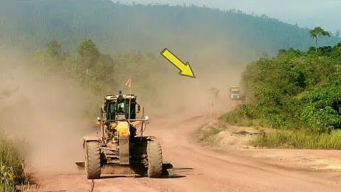 Dusty mine line work grader.