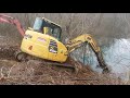 Cleaning out a plugged culvert pipe under the railroad