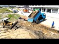 Mix 2 project showing landfilling d20p bulldozer working push stone and dirt