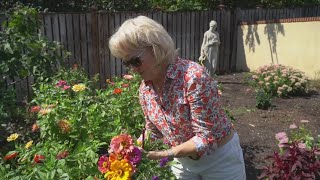 A woman exchanges flowers for donations to her local food bank