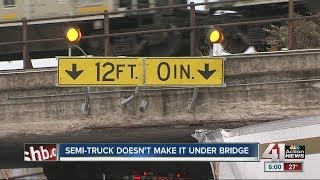 Semi-truck driver tries his luck in tight squeeze overpass, gets stuck