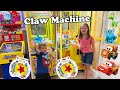 2 claw machines full of disney pixar blind bags