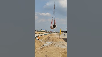 Mobile crane help workers install drainage system